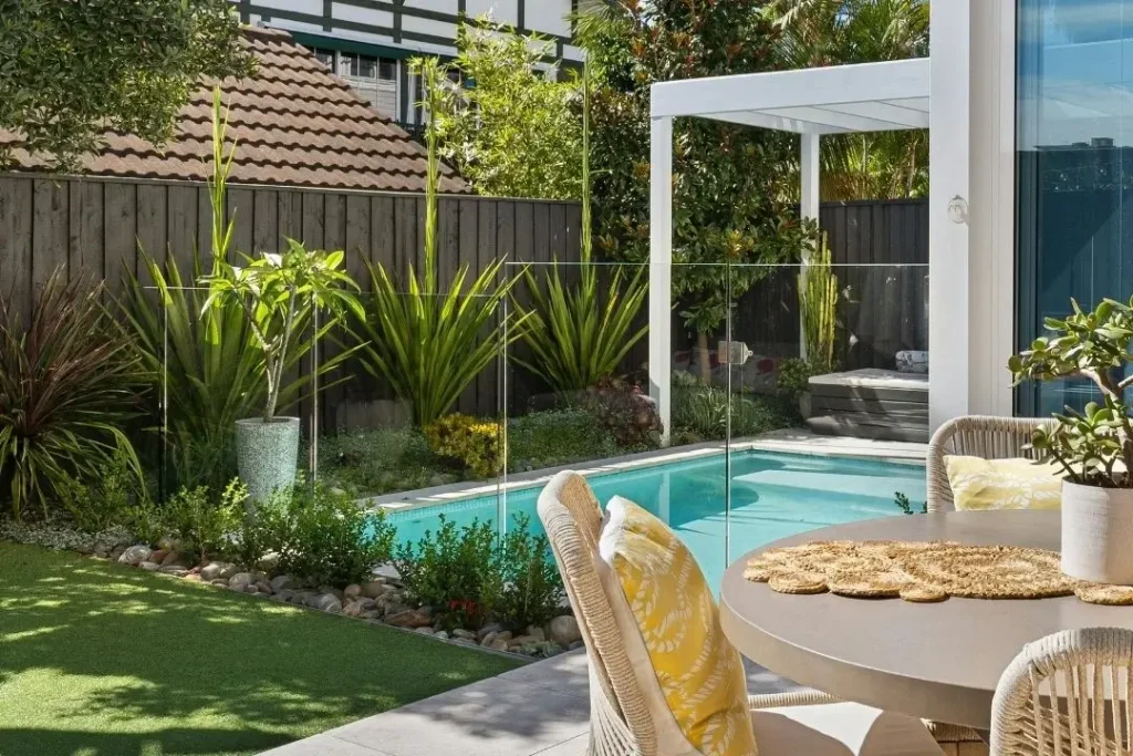 pool area with glass fence and timber boundary fence